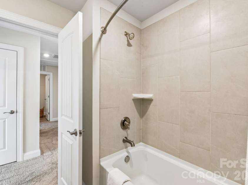 148 Tanner Loop, Troutman, NC 28166.  MLS# CAR4401637, YatesRealty ID 36232. Upstairs hall bath has tub shower combo.
