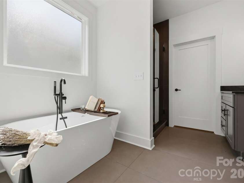 75 2nd Avenue, Taylorsville, NC 28681.  MLS# CAR4394328, YatesRealty ID 36247. Soaking tub in primary suite on main level