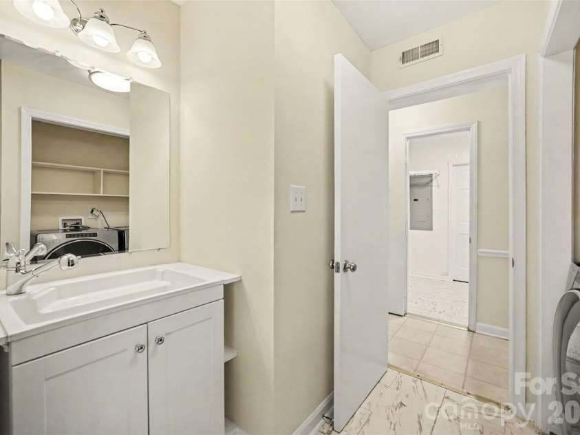 2248 Lawton Bluff Road, Charlotte, NC 28226.  MLS# CAR4418434, YatesRealty ID 36254. Main level half bath and laundry