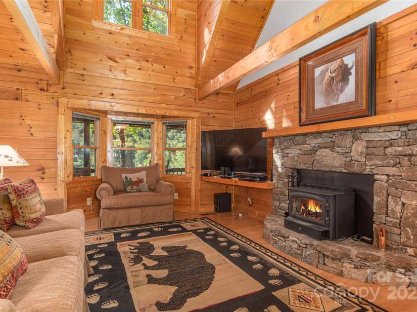 235 Timucua Trail, Waynesville, NC 28786.  MLS# CAR4301389, YatesRealty ID 3628. Gather around the fireplace.