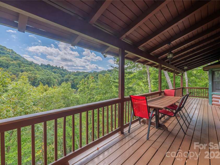 235 Timucua Trail, Waynesville, NC 28786.  MLS# CAR4301389, YatesRealty ID 3628. Unwind on the expansive back deck.