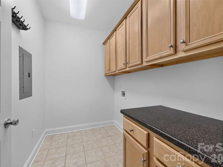 8955 Rosalyn Glen Road, Cornelius, NC 28031.  MLS# CAR4396668, YatesRealty ID 36286. Dedicated Large Sized Laundry Room with extra cabinet space
