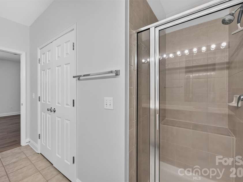 8955 Rosalyn Glen Road, Cornelius, NC 28031.  MLS# CAR4396668, YatesRealty ID 36286. Large walk in Shower with bench