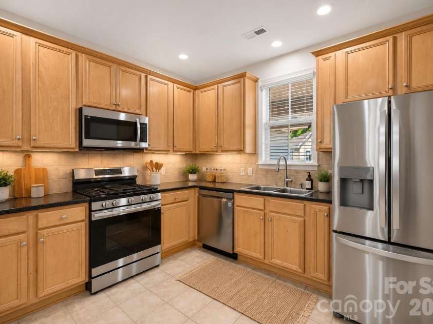 8955 Rosalyn Glen Road, Cornelius, NC 28031.  MLS# CAR4396668, YatesRealty ID 36286. Staged Bright Kitchen with Ample Cupboard Space