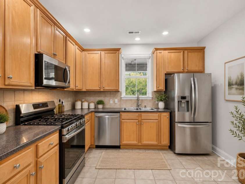 8955 Rosalyn Glen Road, Cornelius, NC 28031.  MLS# CAR4396668, YatesRealty ID 36286. Staged Kitchen with gas oven and stainless steel appliances