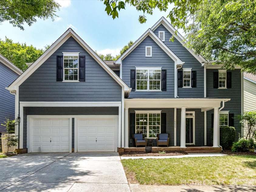 18625 The Commons Boulevard, Cornelius, NC 28031.  MLS# CAR4397710, YatesRealty ID 36310. Classic curb appeal shines with this beautifully maintained home featuring timeless architecture, a welcoming covered front porch, mature landscaping, and an attached two-car garage.