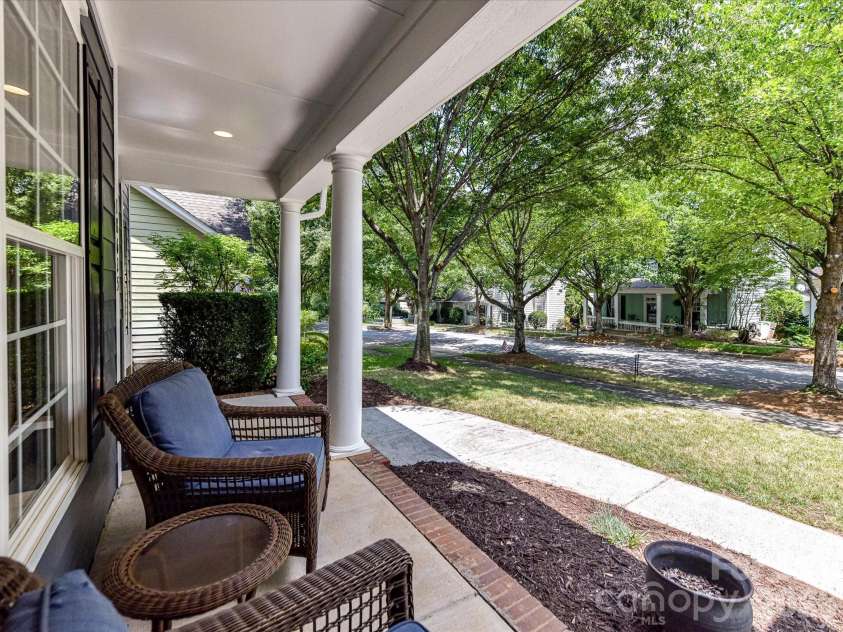 18625 The Commons Boulevard, Cornelius, NC 28031.  MLS# CAR4397710, YatesRealty ID 36310. Relax and enjoy the charm of the welcoming covered front porch, the perfect place to unwind while overlooking the peaceful, tree-lined streetscape.