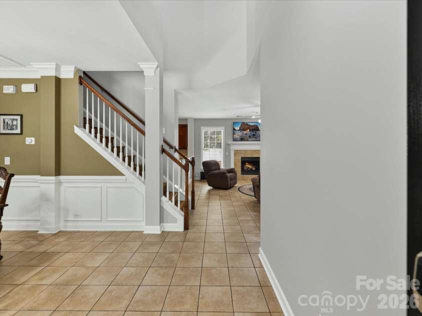 18625 The Commons Boulevard, Cornelius, NC 28031.  MLS# CAR4397710, YatesRealty ID 36310. Step inside to a bright, welcoming entryway featuring elegant wainscoting, soaring ceilings, and an open view into the main living spaces.