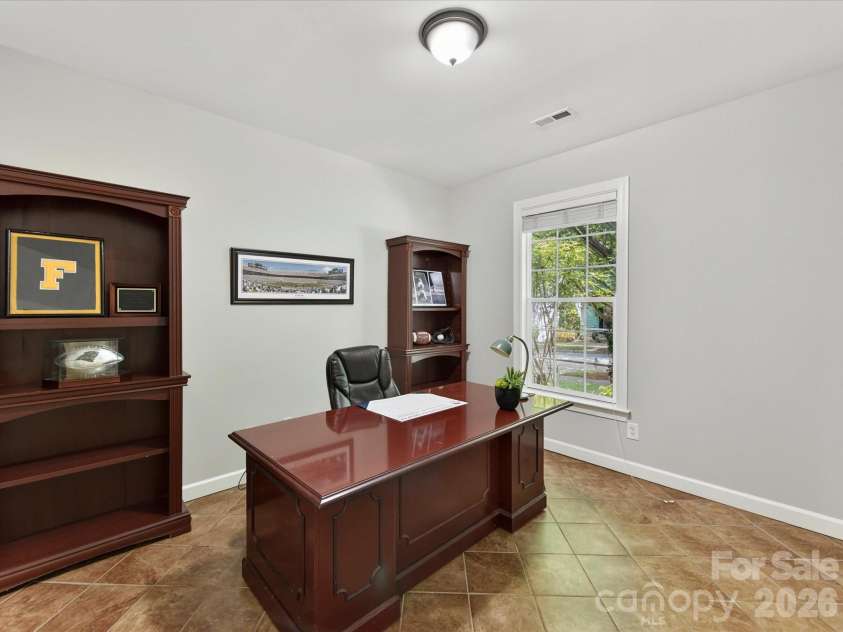 18625 The Commons Boulevard, Cornelius, NC 28031.  MLS# CAR4397710, YatesRealty ID 36310. The dedicated main-level office with French doors offers a quiet, versatile space ideal for working from home, studying, or managing everyday tasks.