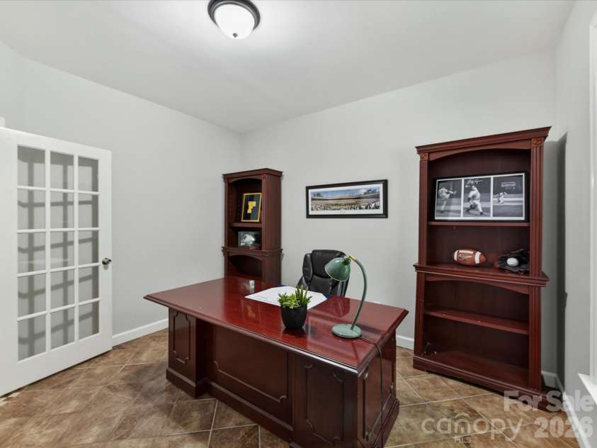 18625 The Commons Boulevard, Cornelius, NC 28031.  MLS# CAR4397710, YatesRealty ID 36310. The dedicated main-level office with French doors offers a quiet, versatile space ideal for working from home, studying, or managing everyday tasks.