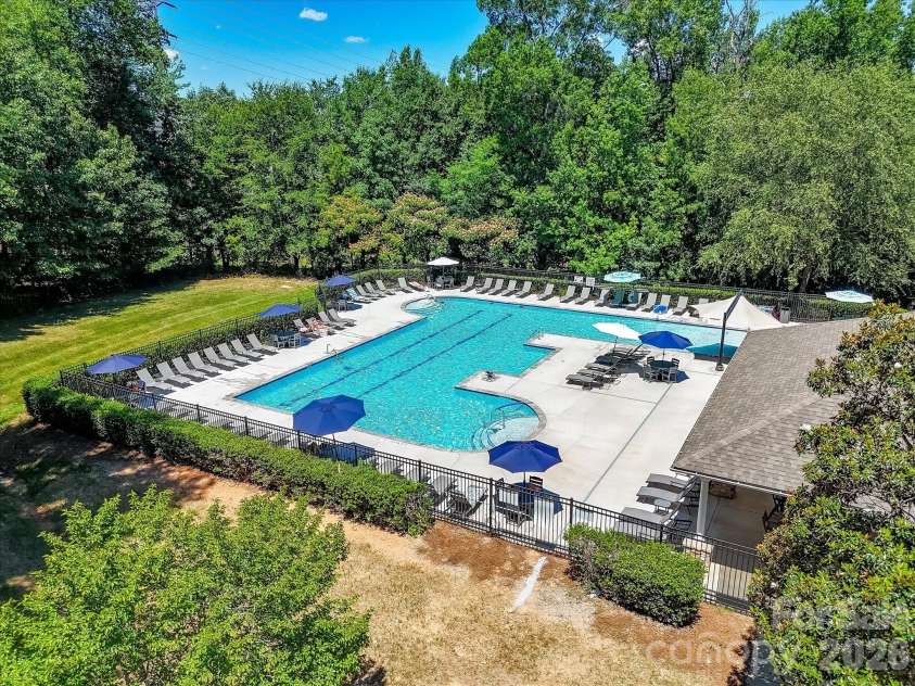 18625 The Commons Boulevard, Cornelius, NC 28031.  MLS# CAR4397710, YatesRealty ID 36310. The resort-style community pool features expansive sun decks, ample lounge seating, and beautifully maintained surroundings, providing the perfect place to relax and enjoy the neighborhood amenities.