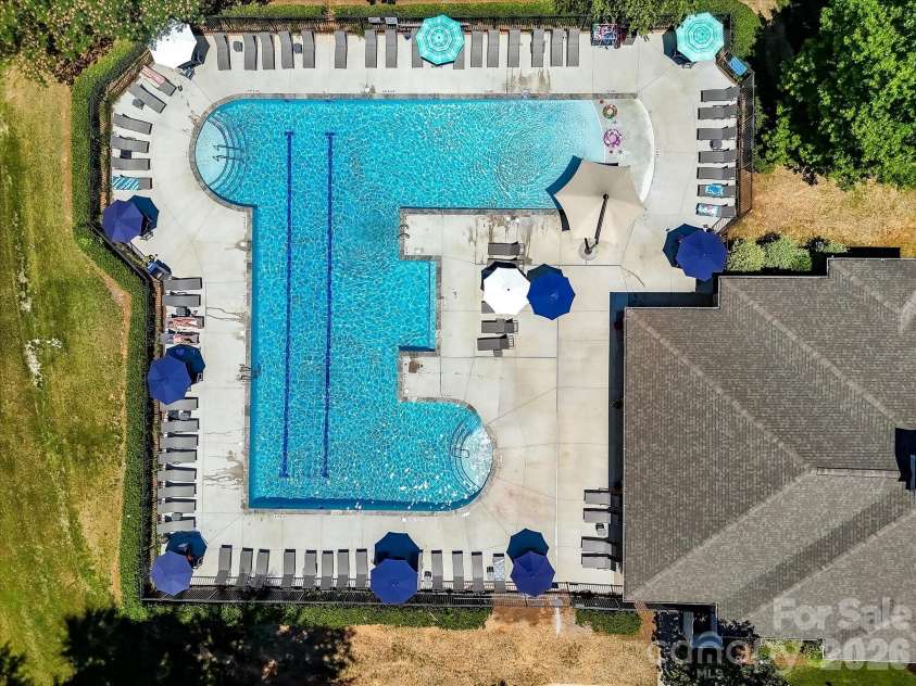 18625 The Commons Boulevard, Cornelius, NC 28031.  MLS# CAR4397710, YatesRealty ID 36310. The resort-style community pool features expansive sun decks, ample lounge seating, and beautifully maintained surroundings, providing the perfect place to relax and enjoy the neighborhood amenities.