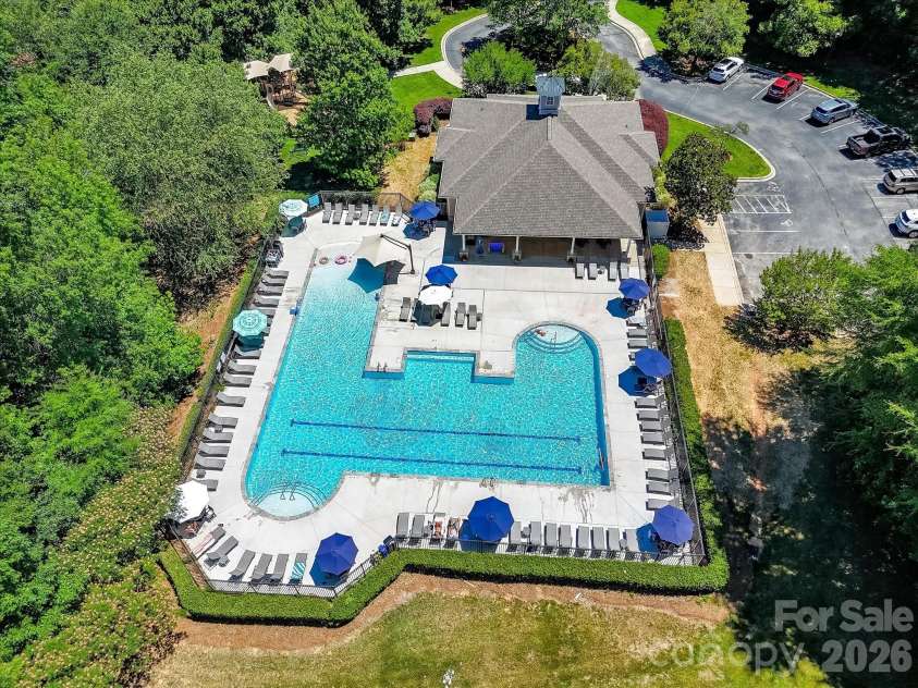 18625 The Commons Boulevard, Cornelius, NC 28031.  MLS# CAR4397710, YatesRealty ID 36310. The resort-style community pool features expansive sun decks, ample lounge seating, and beautifully maintained surroundings, providing the perfect place to relax and enjoy the neighborhood amenities.
