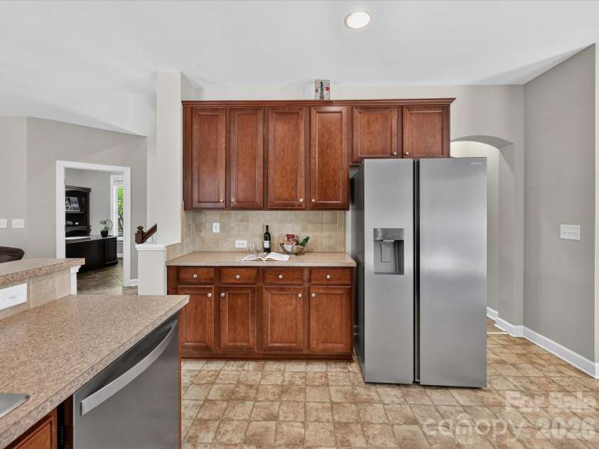 18625 The Commons Boulevard, Cornelius, NC 28031.  MLS# CAR4397710, YatesRealty ID 36310. The spacious kitchen features abundant cabinetry, generous counter space, stainless steel appliances, a convenient breakfast bar, and an open layout overlooking the Great Room for effortless everyday living and