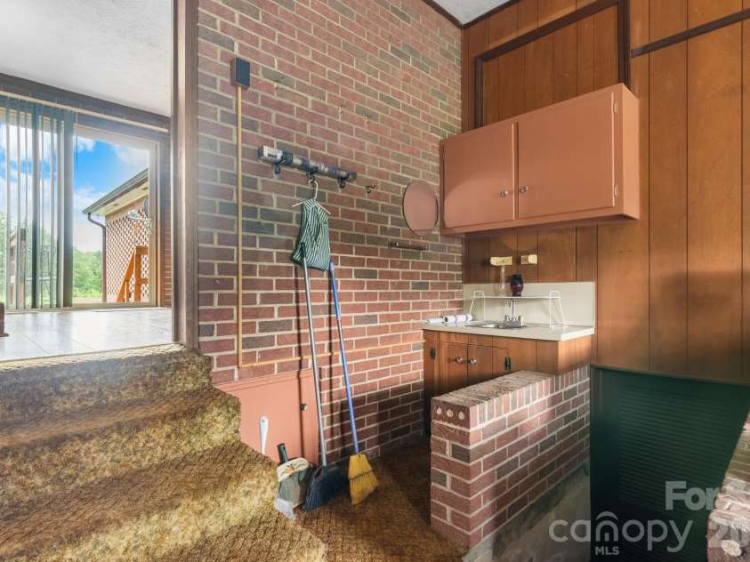 316 Drexel Road, Morganton, NC 28655.  MLS# CAR4414904, YatesRealty ID 3633. Laundry room with sink and washer/dryer. Access to the partial basement.
