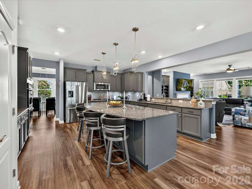 3029 Oliver Stanley Trail, Lancaster, SC 29720.  MLS# CAR4400413, YatesRealty ID 36334. Large Kitchen with Ample Cabinet Storage, Roll Out Shelving, Granite Counters, LVP Flooring