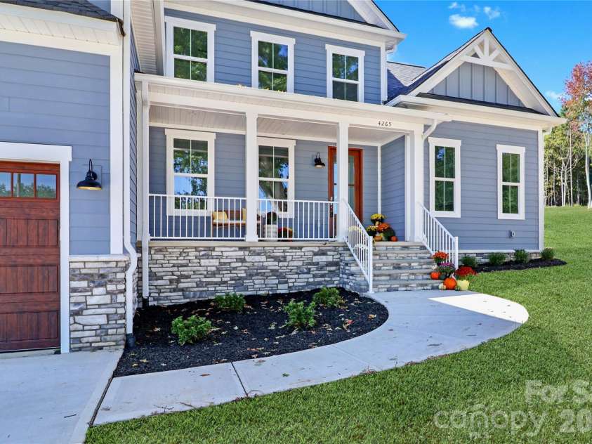 4265 Candlewood Drive, Sherrills Ford, NC 28673.  MLS# CAR4350411, YatesRealty ID 3636. A welcoming front porch invites family and friends with charm. This space is designed to be an extension of the home, offering a comfortable area for relaxation and socializing.