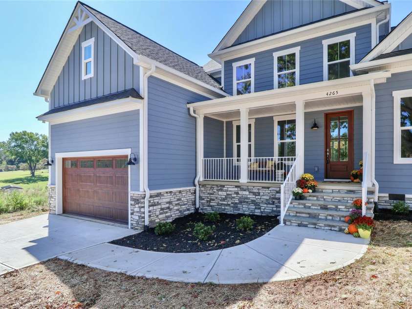 4265 Candlewood Drive, Sherrills Ford, NC 28673.  MLS# CAR4350411, YatesRealty ID 3636. The spacious driveway, attached garage, and front walkway all add character and elegance to this custom-built home. The design elements work together to create curb appeal.