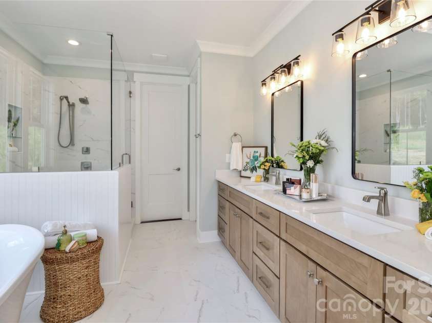 4265 Candlewood Drive, Sherrills Ford, NC 28673.  MLS# CAR4350411, YatesRealty ID 3636. This bathroom offers a luxurious and relaxing experience. The design elements incorporate calming colors, natural materials, while highlighting features including a soaking tub, a rain shower, and shower seating.