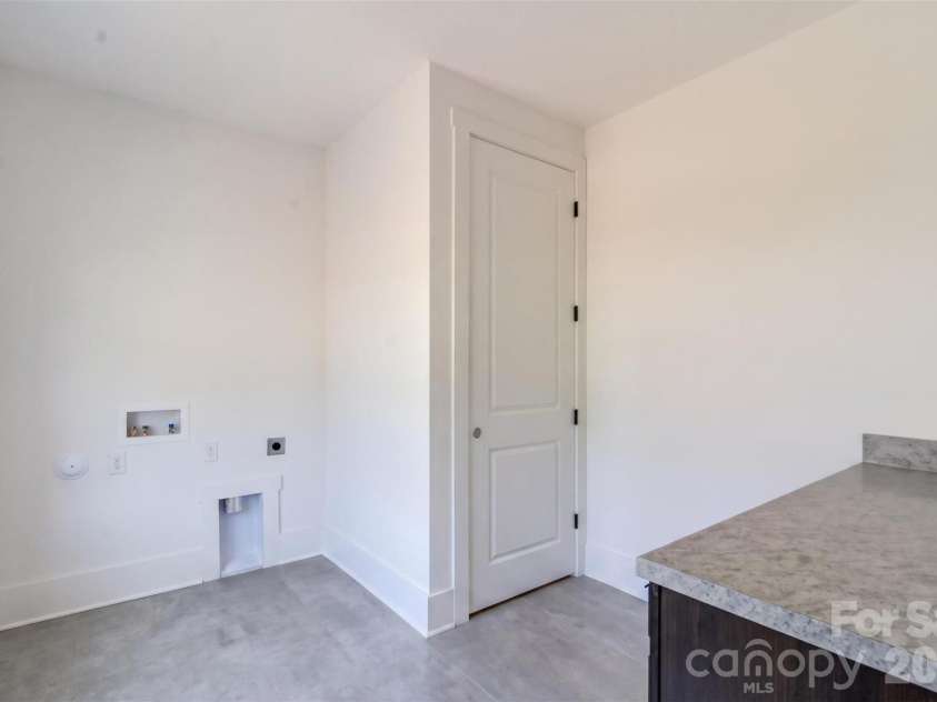 4919 Potter Road, Matthews, NC 28104.  MLS# CAR4395738, YatesRealty ID 36381. Laundry Room with Folding Table