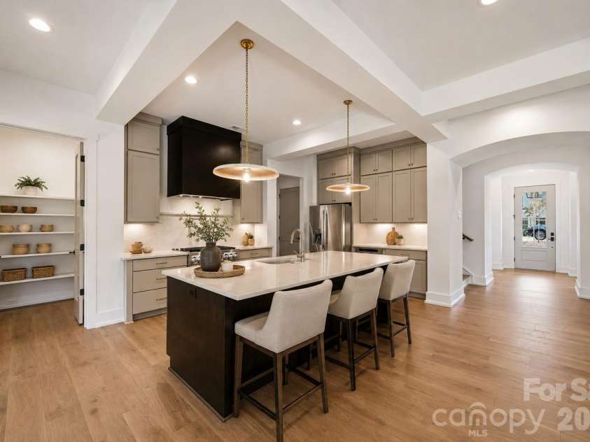 7207 Benita Drive, Charlotte, NC 28212.  MLS# CAR4389589, YatesRealty ID 36393. Representative photo- Designer kitchen, linear range hood, quartz countertop and backsplash, LG SKS appliances.