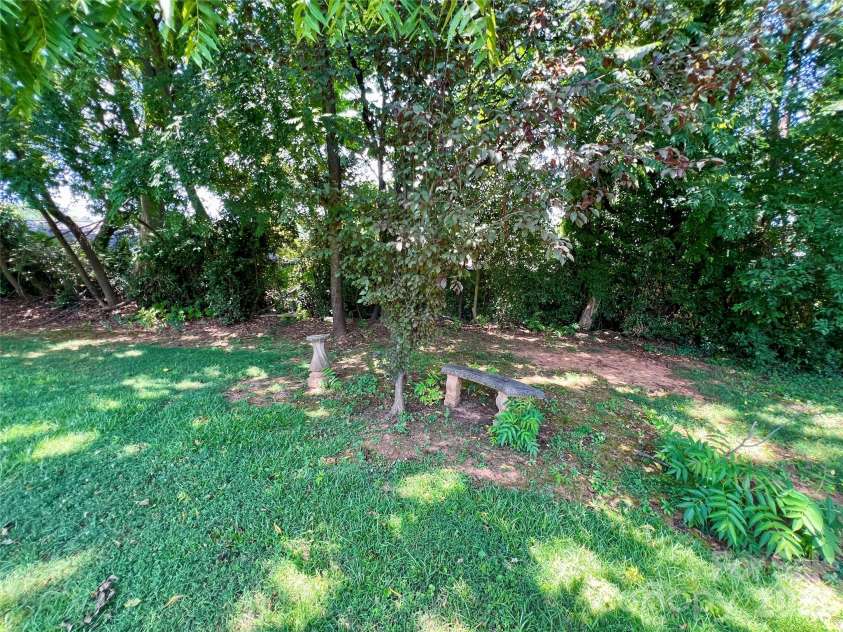2307 Mclean Street, Gastonia, NC 28054.  MLS# CAR4402528, YatesRealty ID 36421. Sitting area under trees