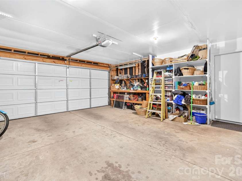 10316 Bon Meade Lane, Cornelius, NC 28031.  MLS# CAR4395622, YatesRealty ID 36425. Garage with storage and workbench