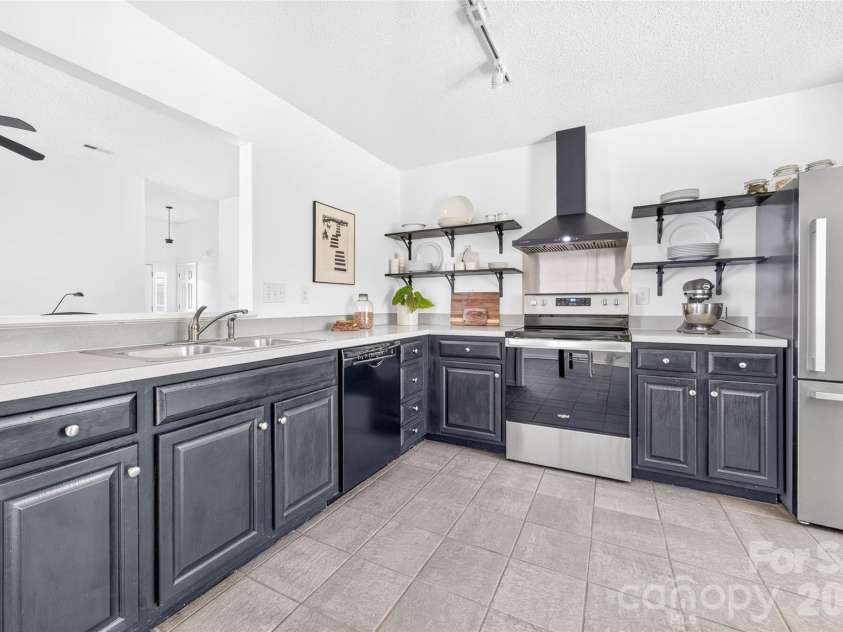 10316 Bon Meade Lane, Cornelius, NC 28031.  MLS# CAR4395622, YatesRealty ID 36425. Kitchen with updated range hood (2026) & electric range (2022)