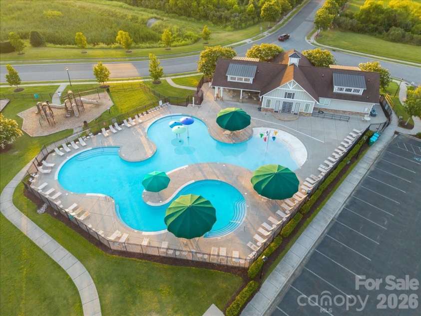 1019 Sunflower Lane, Indian Trail, NC 28079.  MLS# CAR4402543, YatesRealty ID 36431. Community resort-style pool with oversized umbrellas, walk-out beach area, mushroom spray fountains, tipping buckets and a covered picnic area