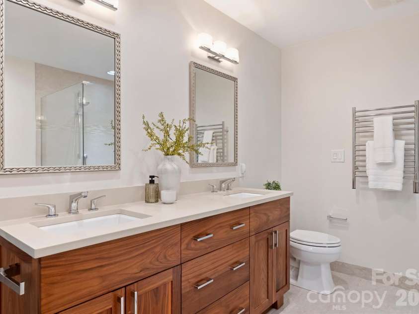 201 Hillside Avenue, Charlotte, NC 28209.  MLS# CAR4377112, YatesRealty ID 36500. The Primary Bath features a custom handsome walnut vanity with double cast under-mount sinks.