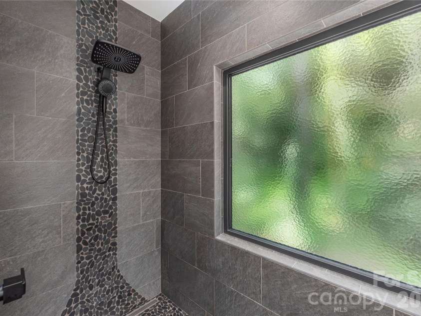 30 Garren View Drive, Fairview, NC 28730.  MLS# CAR4397082, YatesRealty ID 36503. Indoor shower with a nature-forward vibe