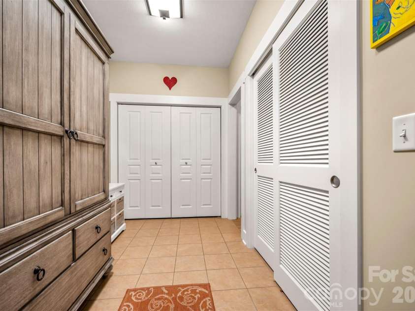 584 Summerfield Place, Flat Rock, NC 28731.  MLS# CAR4401680, YatesRealty ID 36549. Mudroom with two storage closets