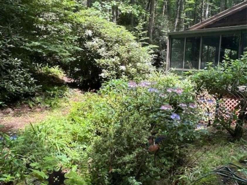 76 Azalea Court, Sapphire, NC 28774.  MLS# CAR4308118, YatesRealty ID 3657. Creek behind house