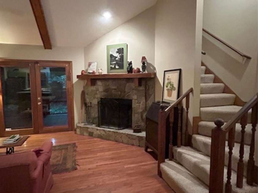 76 Azalea Court, Sapphire, NC 28774.  MLS# CAR4308118, YatesRealty ID 3657. Fireplace and stairs to primary bedroom 