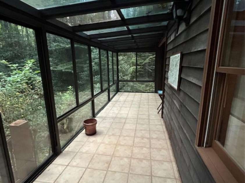 76 Azalea Court, Sapphire, NC 28774.  MLS# CAR4308118, YatesRealty ID 3657. Sun room looking over creek