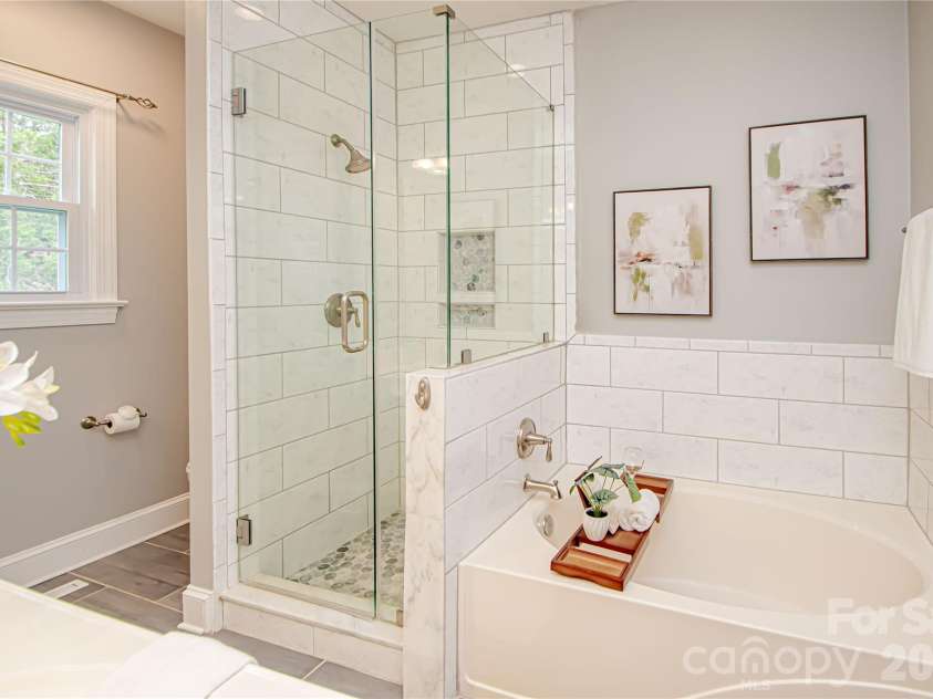 2806 Saintfield Place, Charlotte, NC 28270.  MLS# CAR4366508, YatesRealty ID 36594. En Suite Bathroom cont: large current rectangular tile, double sinks, updated light fixtures. YOUR  linen closet is left of window and the Commode is to the right of the window.