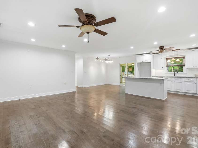 6081 Cambridge Drive, Harrisburg, NC 28075.  MLS# CAR4410918, YatesRealty ID 36625. Living room with kitchen