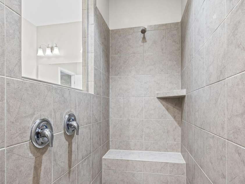 623 Amber Meadows Way, Fort Mill, SC 29708.  MLS# CAR4402607, YatesRealty ID 36714. Large Walk In Shower tiled with built in seat