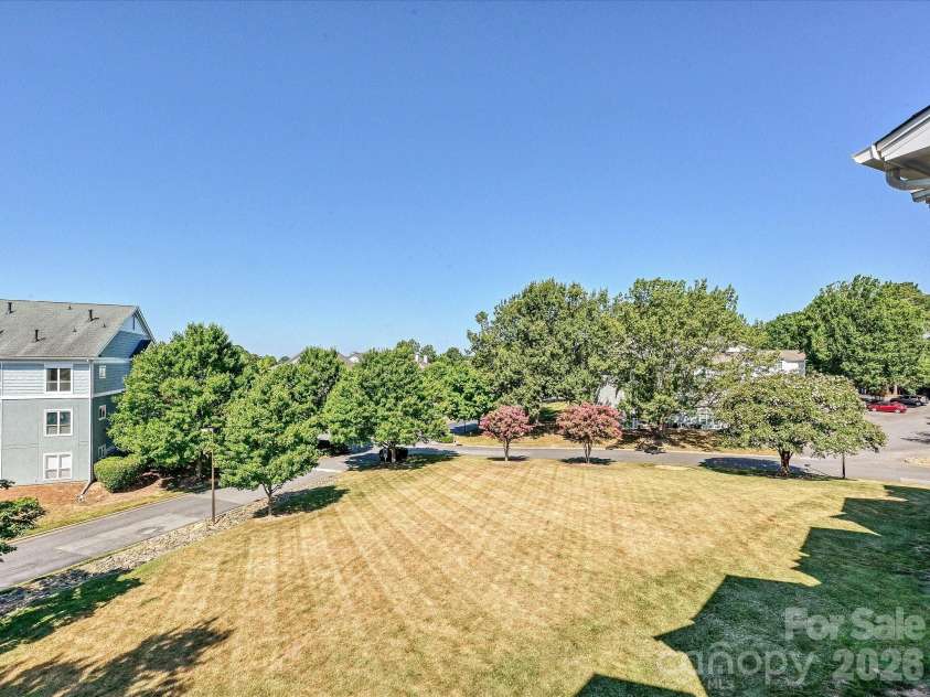 18817 Nautical Drive, Cornelius, NC 28031.  MLS# CAR4402738, YatesRealty ID 36724. Take in peaceful, tree-lined views from your private covered balcony, the perfect spot for morning coffee or evening relaxation.