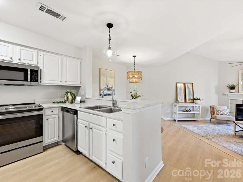 18817 Nautical Drive, Cornelius, NC 28031.  MLS# CAR4402738, YatesRealty ID 36724. The bright, open kitchen features stainless steel appliances, ample cabinetry, and seamless flow into the main living area.