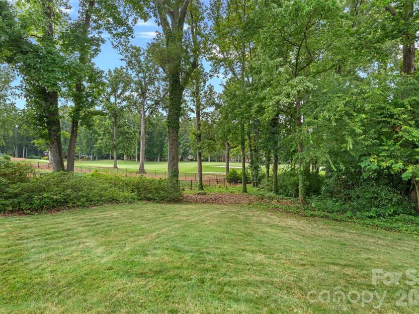19322 River Falls Drive, Davidson, NC 28036.  MLS# CAR4400666, YatesRealty ID 36729. Rear lawn with view of golf course