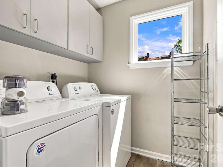 9031 J M Keynes Drive, Charlotte, NC 28262.  MLS# CAR4406099, YatesRealty ID 36738. Laundry room with cabinets
