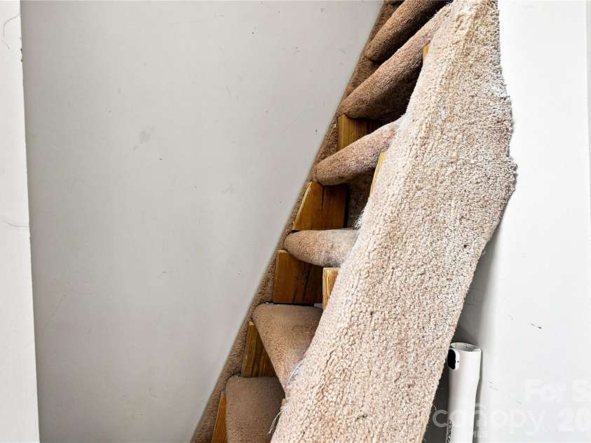 9031 J M Keynes Drive, Charlotte, NC 28262.  MLS# CAR4406099, YatesRealty ID 36738. Stairs to storage space