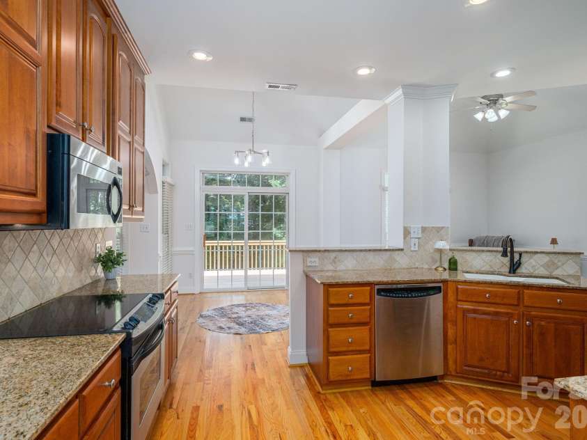 4017 Foxes Trail, Cramerton, NC 28032.  MLS# CAR4392381, YatesRealty ID 36768. Kitchen open to entertaining area and deck.