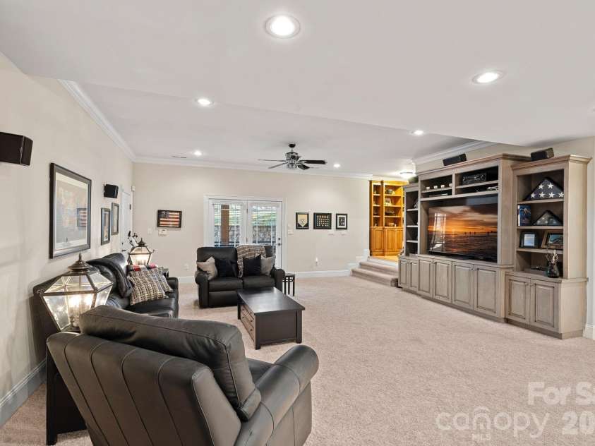 8056 Windsong Road, Denver, NC 28037.  MLS# CAR4338540, YatesRealty ID 3683. Basement/lower level family room with access to the lower screened porch.