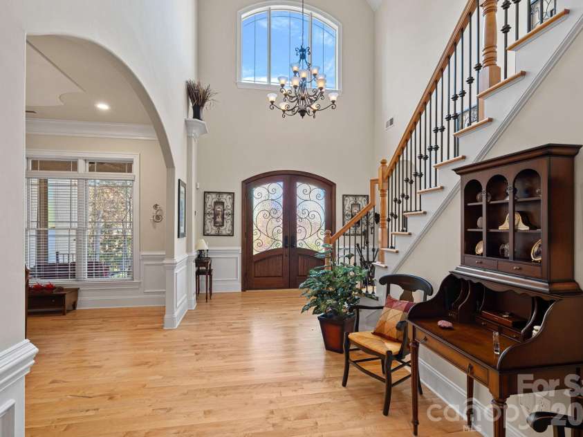 8056 Windsong Road, Denver, NC 28037.  MLS# CAR4338540, YatesRealty ID 3683. Bright, open entry foyer with vaulted ceilings provides access to the den, living room, and dining room, and one of two staircases to the upper level.