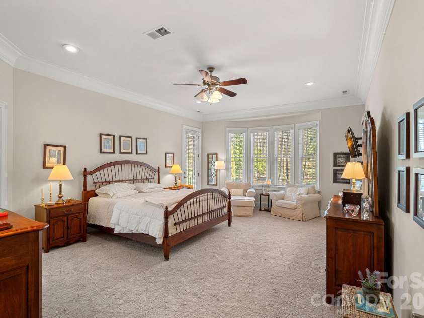 8056 Windsong Road, Denver, NC 28037.  MLS# CAR4338540, YatesRealty ID 3683. Primary bedroom with en-suite bathroom. Will you choose to start your day on the covered balcony or screened-in porch?