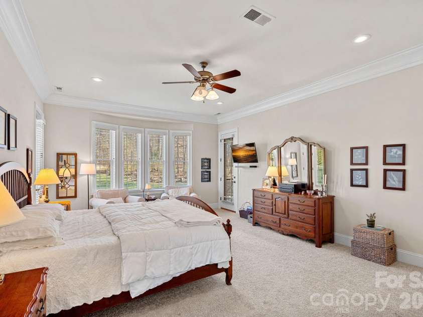 8056 Windsong Road, Denver, NC 28037.  MLS# CAR4338540, YatesRealty ID 3683. Primary bedroom with en-suite bathroom. Will you choose to start your day on the covered balcony or screened-in porch?