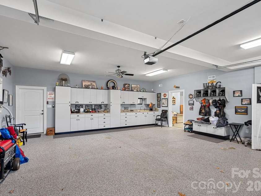 8056 Windsong Road, Denver, NC 28037.  MLS# CAR4338540, YatesRealty ID 3683. Second garage with built-ins/workshop area, and access to a gym and utility storage.