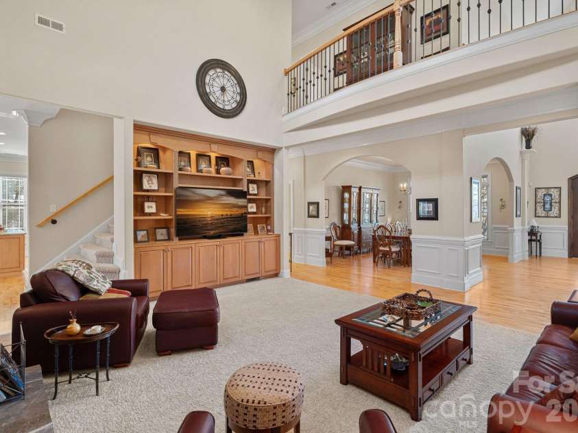 8056 Windsong Road, Denver, NC 28037.  MLS# CAR4338540, YatesRealty ID 3683. Spacious living room with vaulted ceilings, stone fireplace, and custom built-ins.